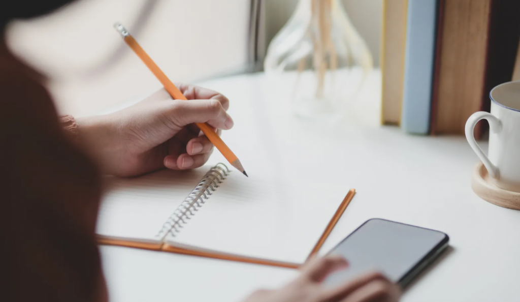 writing on a notebook
